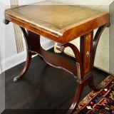 F06. Leather topped side table with shelf. 27”h x 26”w x 19”d 